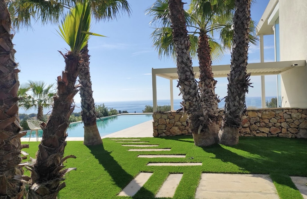 Espace piscine vue mer avec palmiers et gazon synthétique Luxe 50
